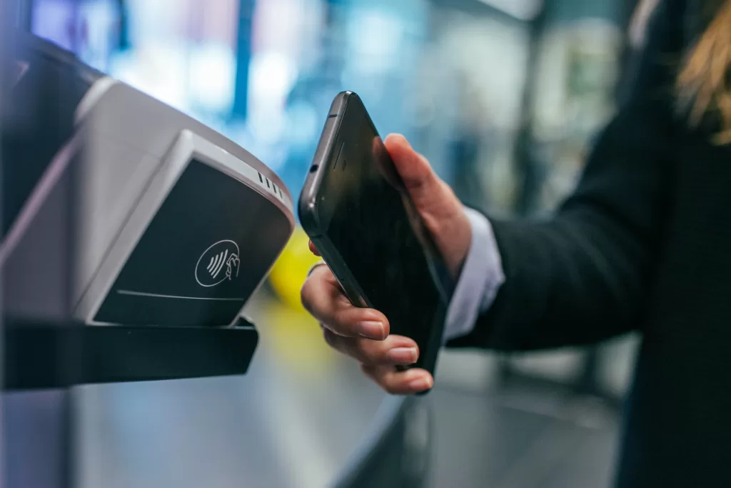 Men using fintech to make a tap to pay with a smartphone